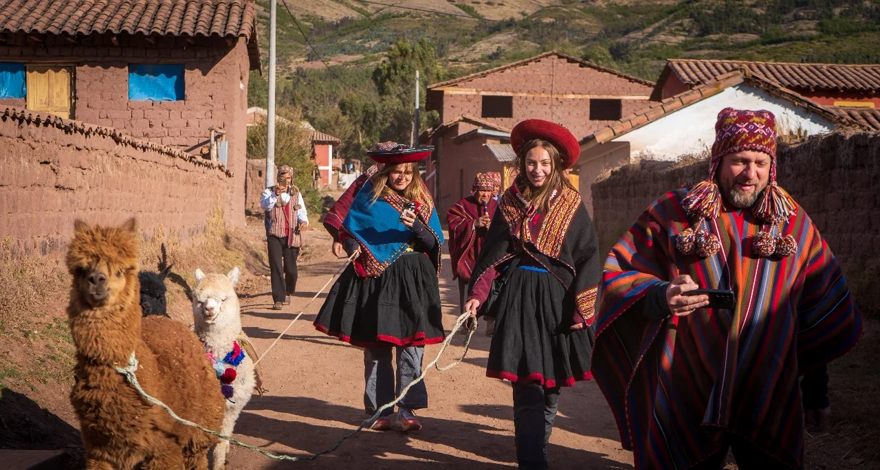 A family holding llamas as part of experiential Tourism