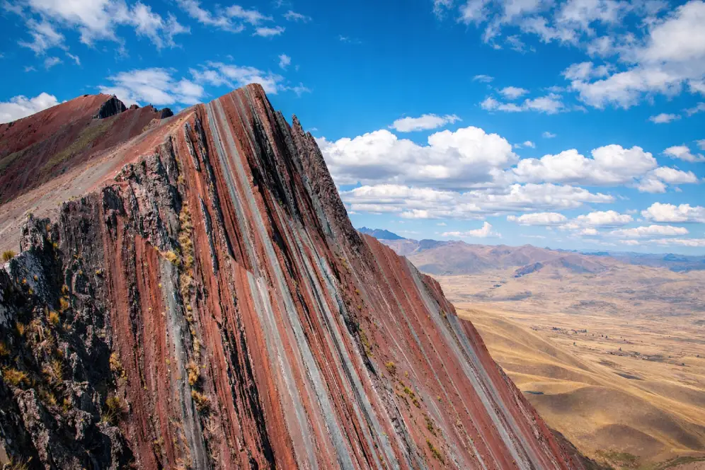Pallay Punchu Rainbow Mountain in Cusco with sharp mineral stripes and panoramic Andean landscape