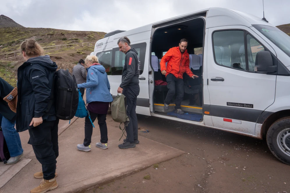 Tourists getting off a tour van in Palccoyo to begin the hike to the rainbow mountains in Cusco.